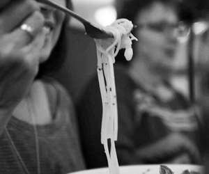 restaurant patron eating a bowl of pasta